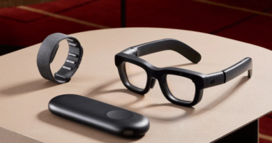 Modern smart glasses with a wrist strap and a sleek casing on a table.