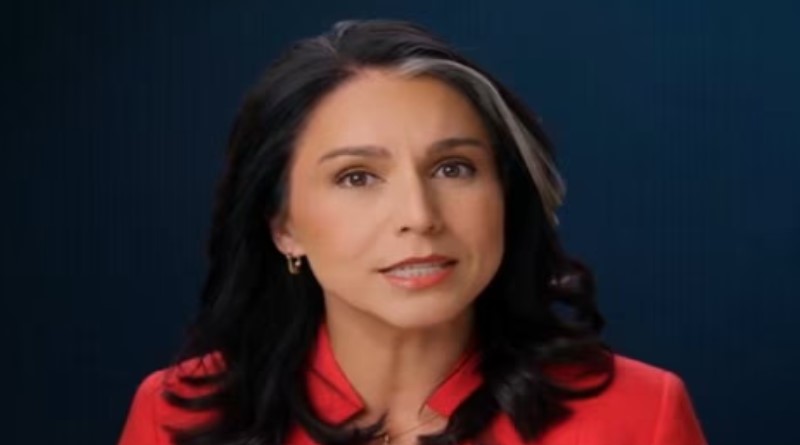 a woman in a red shirt is looking at the camera