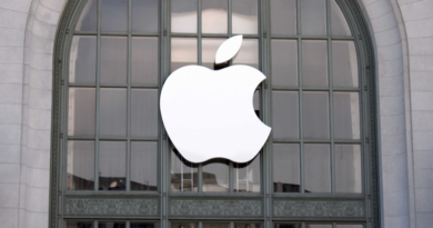 Apple logo in front of a building with arched windows.