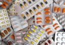 A diverse assortment of pills and tablets stacked together in a disorganized pile.