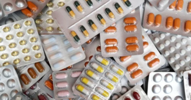 A diverse assortment of pills and tablets stacked together in a disorganized pile.