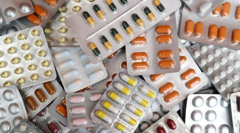 A diverse assortment of pills and tablets stacked together in a disorganized pile.